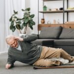 old men falled down on floor and touching head