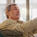 Walking stick, thinking and senior man in home with dementia in nursing home with sickness. Alzheim